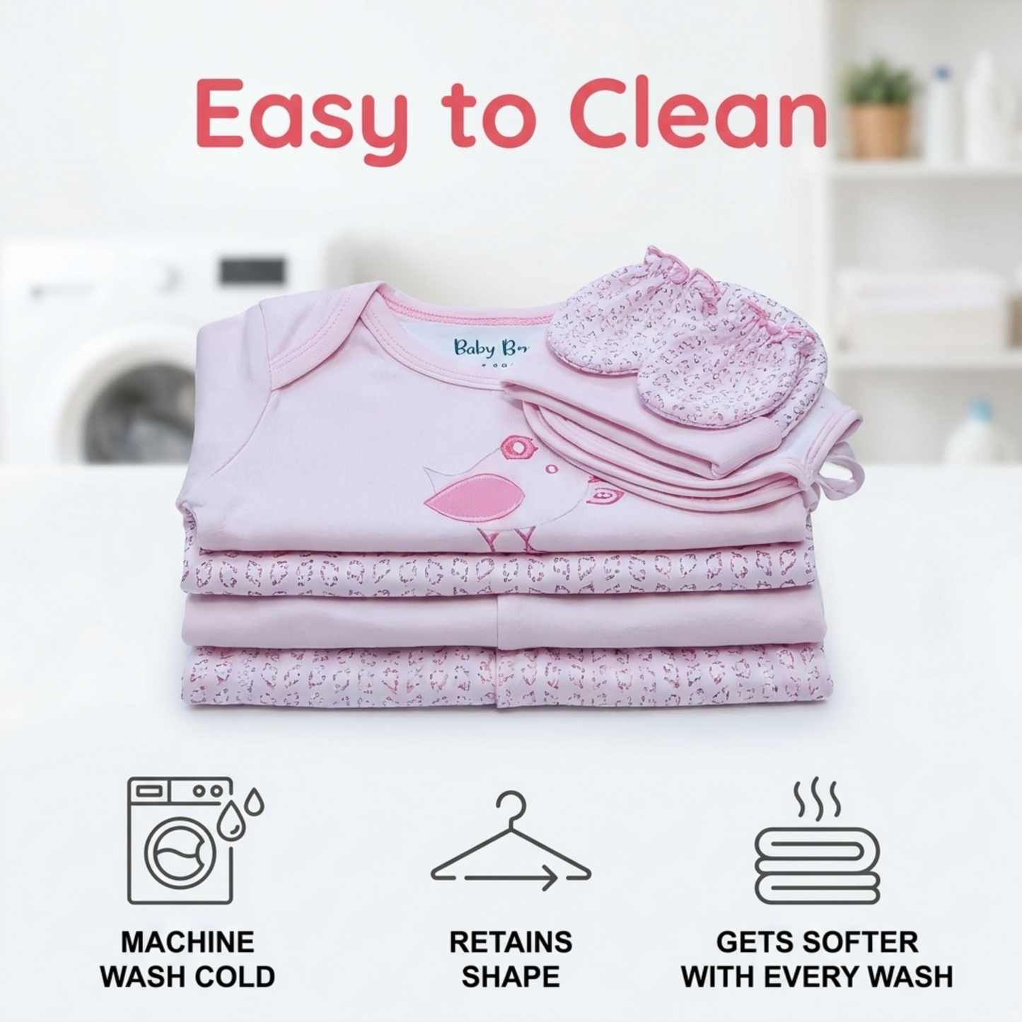 The image is an advertisement for baby clothing, featuring a stack of pink baby clothes and a baby mitten. The text highlights the ease of cleaning, retaining shape, and getting softer with every wash.