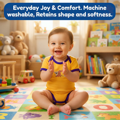 A smiling baby in a yellow onesie sits on a colorful play mat surrounded by toys and books in a cozy, well-lit room.