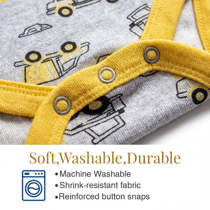 a close-up view of a baby onesie with a yellow and gray pattern featuring construction vehicles. The onesie has a yellow zipper and buttons, and it appears to be machine washable, stretch-resistant, and reinforced with button snaps.
